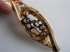 BROSA AUR GALBEN 14 KT,CU DIAMANTE NATURALE ,ART DECO,MARCAJ AL PERIOADEI RESPECTIVE.DIAMANTELE SANT DE 5/5 MM SI DOUA 5/4 MM.ESTE O PIESA UNICAT !